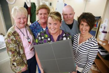Pictured are LincolnHealth Diagnostic Imaging staff members, from left: Lana Brandt, Mary Johnston, Jill Reynolds, Shane Creamer and Pam Hepburn. Jill Reynolds is holding a new wireless digital radiological sensor that makes getting an X-ray at the Miles Campus of LincolnHealth quicker, more convenient and safer. The new sensor also provides images that are as good as any in the state, even at much larger hospitals. Courtesy of LincolnHealth