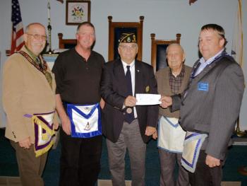 Bay View Masonic Lodge presents the $1,000 donation to purchase flags at its June meeting. Present were District Deputy Charles Billings representing the Maine Masonic Charitable Foundation; Linc Sample of Bay View Lodge who sought funding for flags; Robert Raudenbush, Past Commander of the Charles E. Sherman Jr. Post who received the donation; Harry Pinkham, an active Mason and member of the American Legion; and Michael Alley, presiding officer of Bay View Masonic Lodge. Courtesy of Thomas Pulkkinen