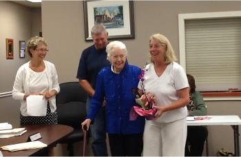 Board Chairman Denise Griffin, far left, presents Leah Sample, center, with a token of the board's appreciation, as the real award arrives sometime in November from the Spirit of America foundation. Sample's children Linc, left, and Debbie, far right, accompanied her. KATRINA CLARK/Boothbay Register