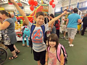 Connor Dover and his sister, Cali Brown, show off their new backpacks they got at Set for Success. Connor is clearly very excited to start school in less than three weeks. KATRINA CLARK/Boothbay Register
