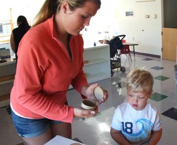 NEW STUDENT AIDAN JEWETT and mom Christian check out some of the items that were placed around the classroom of the new Harbor Montessori School. SUZI THAYER/Boothbay Register
