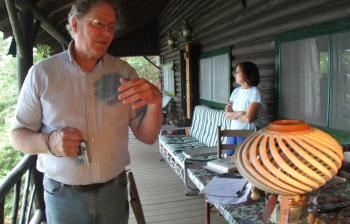 RICHARD CORSON explains the creative process of making of his “open twisted hollow form.” His wife, Camille is in the background. SUZI THAYER/Boothbay Register