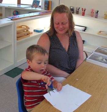 HENRY FULTON works on an art project while his mom Stacey Bennett watches. SUZI THAYER/Boothbay Register