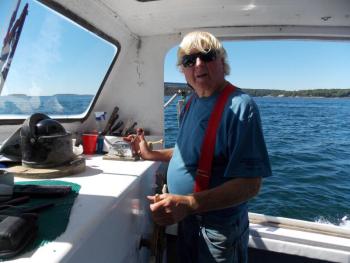 Captain Rusty Court at the wheel of his boat. KATRINA CLARK/Boothbay Register