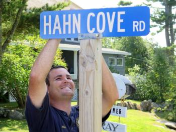 Nick Livingston erects the new sign at McKown Point. Courtesy of Stephen Rubicam