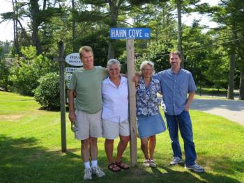 New sign. From left, Robert Hahn, Caroline Andrews, Kit Andrews and Mike Hahn gather around the new road sign at McKown Point honoring their ancestors. Courtesy of Stephen Rubicam