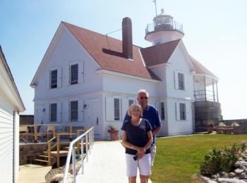 Barb and Dan Aube stand outside the Cuckolds Lighthouse, their home for the summer of 2014. Courtesy of Barb Aube
