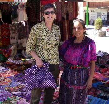 Kathleen Jones bargains with a local huipil seller in Panajachel, Guatemala. Both are happy with the result. Courtesy of Kathleen Jones