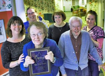 St. Andrews Village Assisted Living Resident Barbara Pond holds the “Excellence in Action” award that St. Andrews Village Assisted Living recently received for scoring in the top 10 percent of their peers in resident satisfaction. Next to Barbara is Village resident Alan Tindal. In the second row, left to right: Elizabeth Barter, RN, Clinical Nursing Manager, Melanie Hibbard, CNA, CRMA, Cathy Rayle, RN, Director of Nursing at the Gregory Wing and Bridy Lewis, CNA, CRMA. Courtesy of LincolnHealth