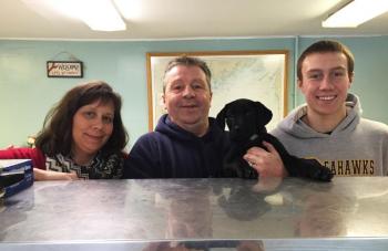 Cathy and Russell Pinkham, along with son Nick Kilgus and newest member of the family, Mandy Mae, at the new Pinkham’s Seafood on Route 27 in Boothbay. SUZI THAYER/Boothbay Register