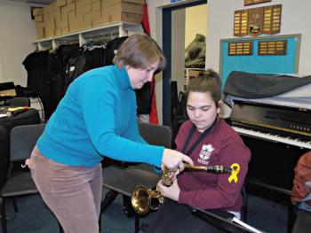 Teacher Molly Winchenbach adjusts student Corey Campbell’s saxophone, which she has never played before, during the “Learn a New Instrument” elective. KATRINA CLARK/Wiscasset Newspaper