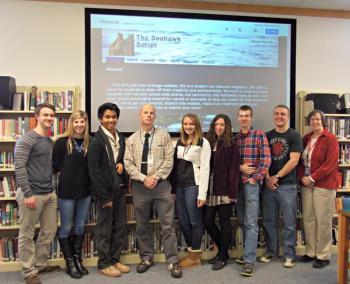The AP Literature Class with the welcome page for the first edition of The Seahawk Script displayed behind them. From left, Collin Thompson, Nicole LaBrecque, Karl Alamo, teacher Mark Gorey, Anna Baumm, Chloe Hoecker, David Machon, Zach Vise and Technology Integrator Barbara Greenstone. KATRINA CLARK/Boothbay Register