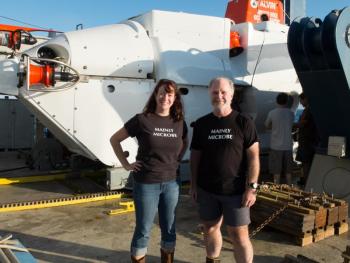 Doctors Beth Orcutt and Graham Shimmield after Alvin dive 4777. While Alvin looks quite large in the background, the total space for passengers is a sphere measuring 8 feet – much of which is taken up by equipment. Courtesy of chief scientist Geoff Wheat, Woods Hole Oceanographic Institution