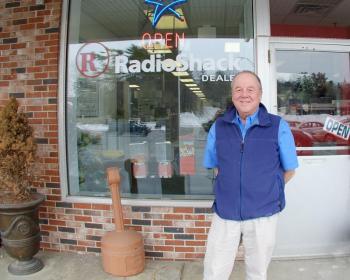 Russell Brackett in front of his store in Boothbay Harbor in March 2014. File photo