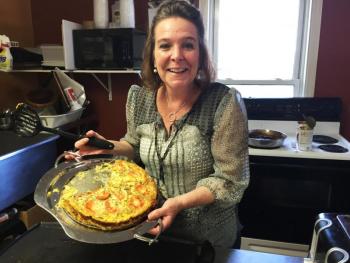 Stacey McLellan holds her quiche special of the day in the kitchen of her restaurant, Capers. SUZI THAYER/Boothbay Register