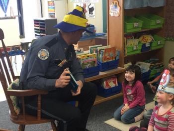 Chief Bob Hasch listens to Cali Brown talk about how much she likes “The Cat in the Hat.” KATRINA CLARK/Boothbay Register