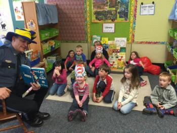 Police Chief Bob Hasch reads to the pre-K class. From left, front row: Bob Hasch, California Brown, Kolton McKenney, Autumn Therrien, Lessie White, Miriam Gordon and Liam Scott. Back row: Mahea Ackley, Demetrius Hilgendorf, Mrs. Rice, Ariyah Green and Eleanor Erwin. KATRINA CLARK/Boothbay Register