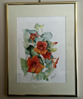 A framed watercolor of flowers painted by Peggy Frantz.