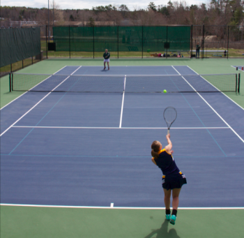 Boothbay’s Anna Baumm serves in a singles match against Carrabec’s Jerzee Stevens. RYAN LEIGHTON/Boothbay Register