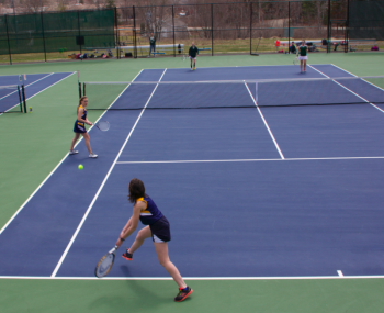 Ellie Demmons lunges for a backhand, while teammate Madison Gaudette looks on from the doubles alley. RYAN LEIGHTON/Boothbay Register