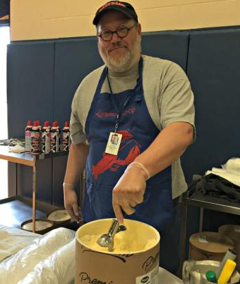 Principal Mark Tess scoops out vanilla ice cream during the ice cream social. KATRINA CLARK/Boothbay Register