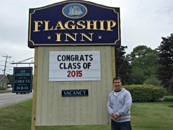 Aaron Blake stands by the sign at Flagship Inn, voted most pet-friendly lodging in all of Maine. KATRINA CLARK/Boothbay Register