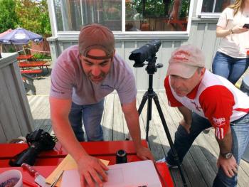 Photographer Ted Axelrod, left, and Lobster Dock owner Mitch Weiss confer about photos for the restaurant’s newly redesigned website. SUZI THAYER/Boothbay Register