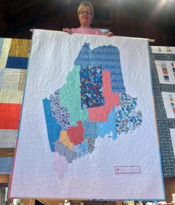 Molly Hutchins displays a quilt that she collaborated on with Deb Boucher. SUZI THAYER/Boothbay Register