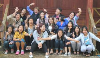 Friends of Thai Daughters founders Patty Zinkowski and Jane McBride with their FTD family, young girls and women who have been helped by the organization over the past decade. The photo was taken this past January at Doi Luang, a remote village in northern Thailand where the inspiration for the FTD began in 2002. Courtesy of FTD
