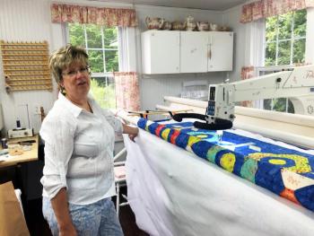 Deb Boucher in her Edgecomb studio, next to her long arm quilting machine. SUZI THAYER/Boothbay Register