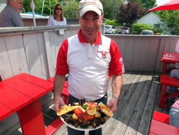 Mitch Weiss shows off one his specialties, seafood fra diavolo. SUZI THAYER/Boothbay Register
