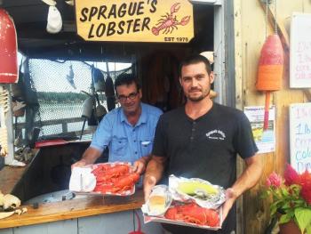 Frank Sprague and son Nate show off some of their lobster dinners at Sprague’s Lobster. SUZI THAYER/Wiscasset Newspaper