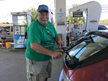 Ken Marston washes the back windshield of this Subaru Impreza as its owner pumps gas. For every $1 of gas bought that morning, five cents was donated to Special Olympics Maine. KATRINA CLARK/Boothbay Register