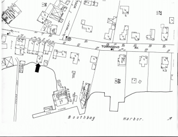 The 1922 Sanborn insurance map shows a stretch of Townsend Avenue from its intersection with Oak Street on the left north to Pottle Realty on the right, extending about halfway to Union Street. The large amount of vacant space east behind the houses is obvious. The one structure that seems to bar passage of a waterfront road is the addition on the east end of the present A Silver Lining; that addition has the legend "Open 1st" meaning one could pass under it. The arrow shows its location. Courtesy of Boothbay Region Historical Society