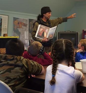 Passamaquoddy educator and birch bark canoe craftsman David Moses Bridges explains construction of traditional dwellings to Great Salt Bay Community School students at the Damariscotta River Association as part of DRA’s Wabanaki Living Skills and Culture Program.
