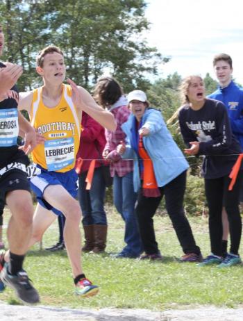 Will Labrecque races to the finish line as fans and teammates cheer him on. Labrecque set a new PR of 20:10. SUE MELLO/Boothbay Register