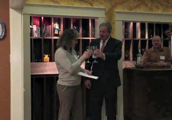 A toast to the partnership by Ellen McFarland, president of the Lincoln County Animal Shelter board, left, with Tony McDonald, president of the Coastal Humane Society board. KATRINA CLARK/Boothbay Register