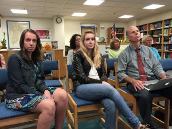 Watching their Champions of Change videos are senior students Ellie Demmons, left, and Gretchen Elder, center, with their AP Language teacher from their junior year, Mark Gorey. KATRINA CLARK/Boothbay Register