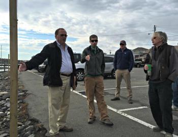 Gathering in the footbridge parking lot to discuss the future of the improvement project. Town Manager Tom Woodin, far left, talks about different ideas he’s heard. To his left, Dan Courtemanch of the DEP, Code Enforcement Officer Geoff Smith, and Bill Royall of Royall Stonework listen. KATRINA CLARK/Boothbay Register