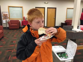 Slade Balsdon, 9, enjoys one of the freshly-grilled hot dogs served at the Business After Hours. KATRINA CLARK/Boothbay Register
