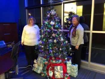 Assistant Manager of Camden National Bank Leslie Barter, left, with teller Ann Reed on either side of the beautiful Christmas tree visible in their window facing Townsend Avenue. KATRINA CLARK/Boothbay Register