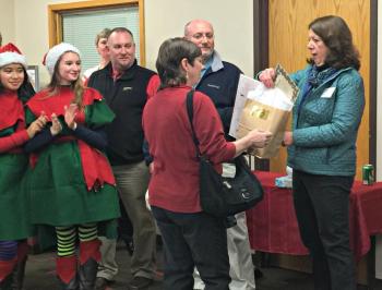 Susan Brackett of Boothbay Harbor Framers presents a door prize to Sherry Hodgdon of The First Bank. KATRINA CLARK/Boothbay Register