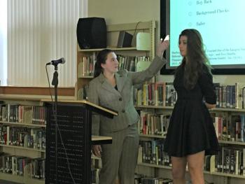Molly Thibault, playing Christian Heyne from the Coalition to Stop Gun Violence, gestures to facts about gun violence on her joint presentations with Angie Perkins, playing Josh Horwitz of the same organization. KATRINA CLARK/Boothbay Register