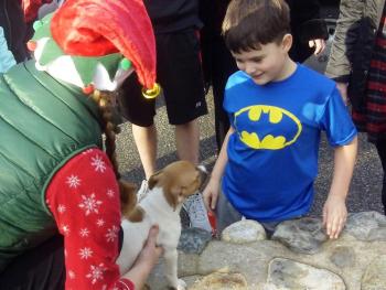 Volunteer elf Heather Straz delivers Rosie to her new bestie, Cameron Kirby, of Portland. Courtesy of Sean Kirby