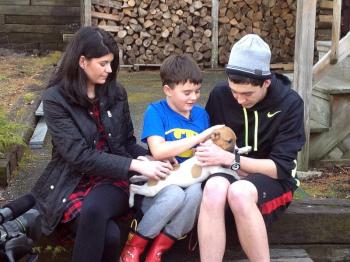 Cameron Kirby, with his sister Jacquelyn and cousin Jake, holds his new puppy, Rosie. Courtesy of Sean Kirby