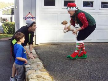 Volunteer elf Heather Straz delivers Rosie to Cameron Kirby on Christmas morning. Courtesy of Sean Kirby
