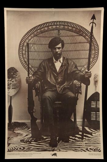 6. Huey Newton seated in wicker chair, 1 of 4 original 1960s Black Panther Party posters to be offered in this auction. Huey Newton weapons poster
