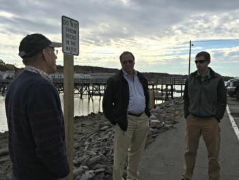 A recent meeting at the footbridge parking lot to determine the feasibility of an improvement project. The footbridge parking lot is one of the town-owned properties that will be directly impacted by the rise in sea levels over the next 50 to 100 years.From left: Selectmen’s Vice Chairman Bill Hamblen, Town Manager Tom Woodin, and Dan Courtemanch of the Maine Department of Environmental Protection. KATRINA CLARK/Boothbay Register