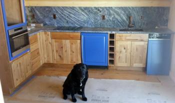 Maximus Gary or "Max” shows off his dad’s extravagant blue slate counter and back splash in the kitchen of the apartment Don Kingsbury is building at 14 Boothbay House Hill. SUZI THAYER/Boothbay Register