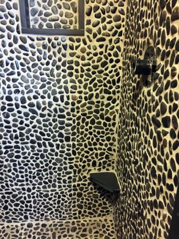 The small black slate corner shelf about a foot up from the floor. is for women to put their feet up on to shave their legs. SUZI THAYER/Boothbay Register